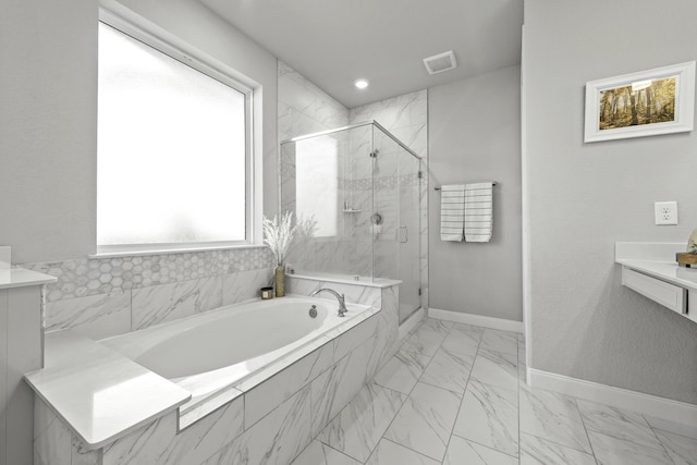 bathroom featuring marble finish floor, a marble finish shower, vanity, baseboards, and a bath