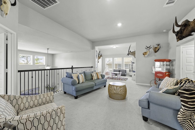 living room featuring light carpet, a healthy amount of sunlight, and visible vents