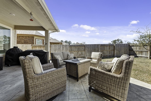 view of patio with an outdoor living space with a fire pit and a fenced backyard