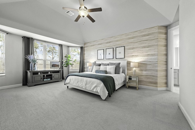 bedroom featuring light carpet, multiple windows, lofted ceiling, and visible vents