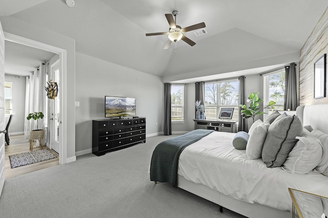 bedroom with multiple windows, visible vents, and vaulted ceiling