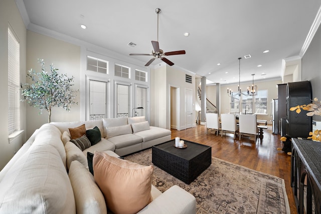 living area featuring dark wood-style flooring, recessed lighting, visible vents, and crown molding