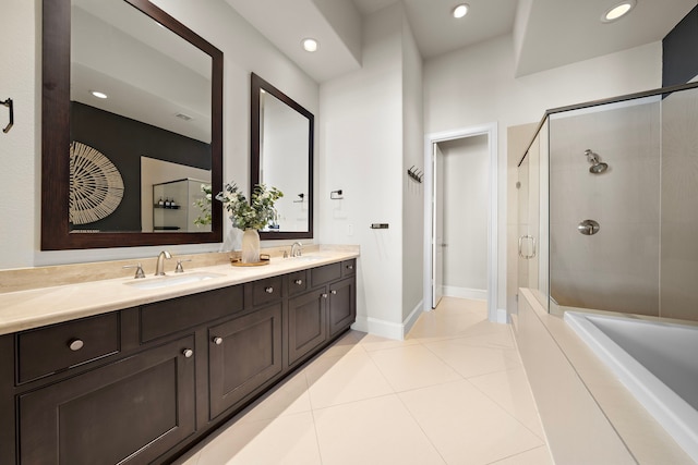 bathroom with a stall shower, tile patterned flooring, a sink, and double vanity