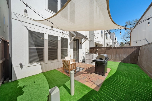 view of patio featuring a fenced backyard and a grill