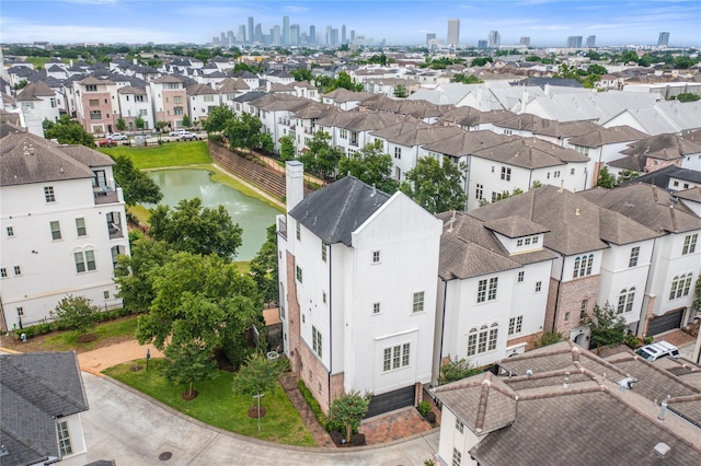 birds eye view of property with a water view, a residential view, and a city view