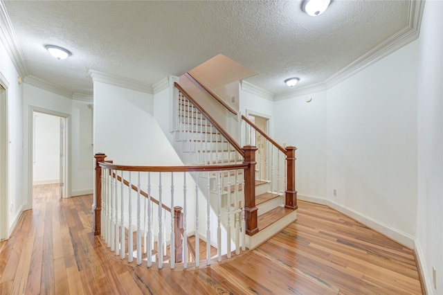 122 Vieux Carre Dr, Houston, TX 77009 - stairs featuring a textured ceiling, wood-type flooring, crown molding, and baseboards