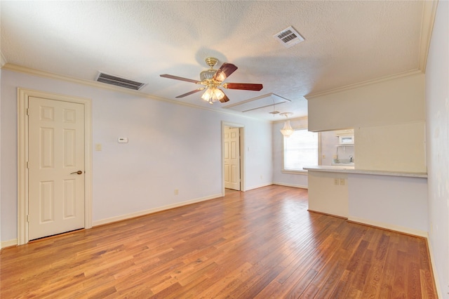 122 Vieux Carre Dr, Houston, TX 77009 - unfurnished room with attic access, crown molding, a ceiling fan, a textured ceiling, and wood finished floors