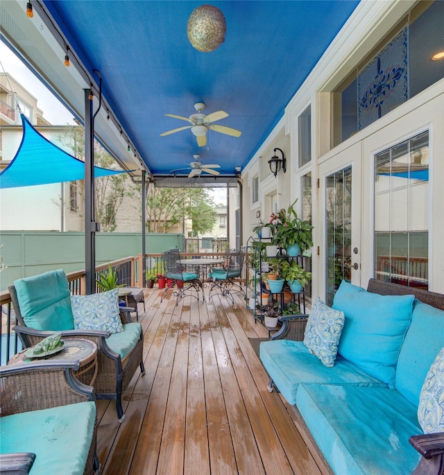 sunroom / solarium featuring ceiling fan