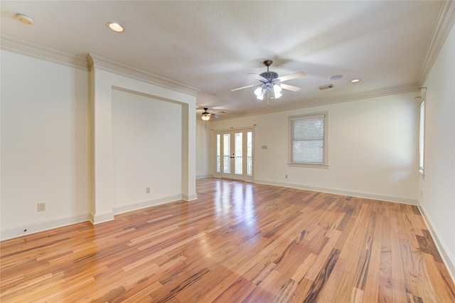 122 Vieux Carre Dr, Houston, TX 77009 - spare room with french doors, ceiling fan, light wood-type flooring, ornamental molding, and baseboards