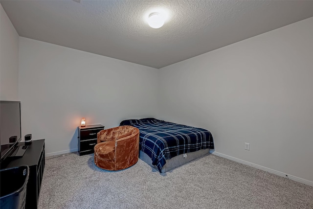 carpeted bedroom with baseboards and a textured ceiling