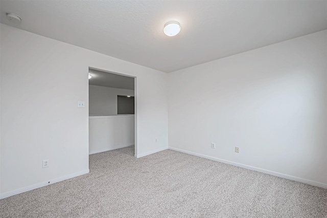 unfurnished bedroom with carpet floors, a closet, and baseboards