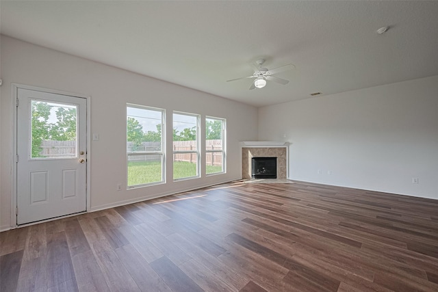 9514 Barr Spring Dr, Humble, TX 77396 - unfurnished living room with a ceiling fan, wood finished floors, and a tile fireplace