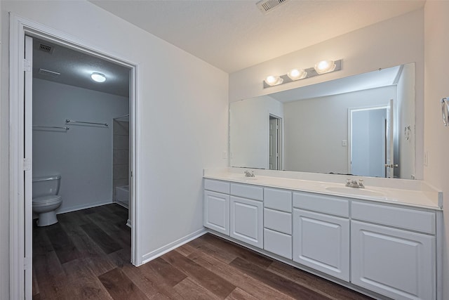9514 Barr Spring Dr, Humble, TX 77396 - full bathroom featuring double vanity, wood finished floors, and shower / bathtub combination