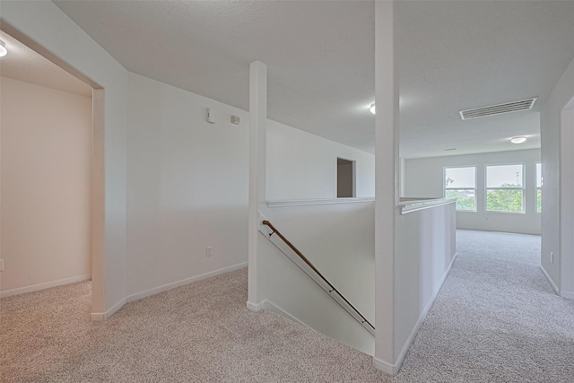 9514 Barr Spring Dr, Humble, TX 77396 - hall with an upstairs landing and light carpet