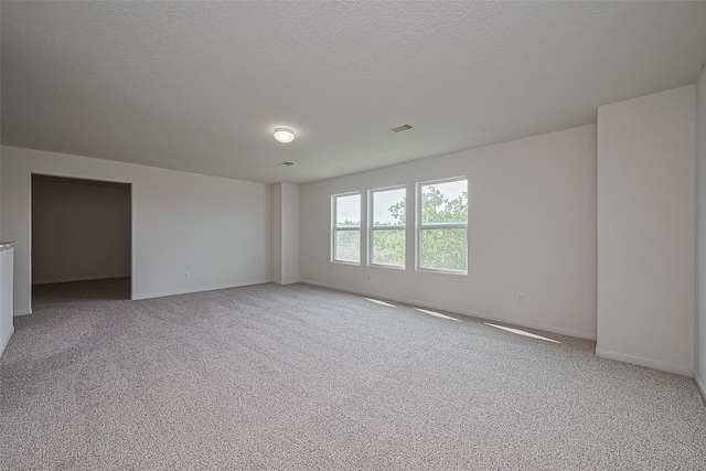 9514 Barr Spring Dr, Humble, TX 77396 - empty room with light carpet and a textured ceiling
