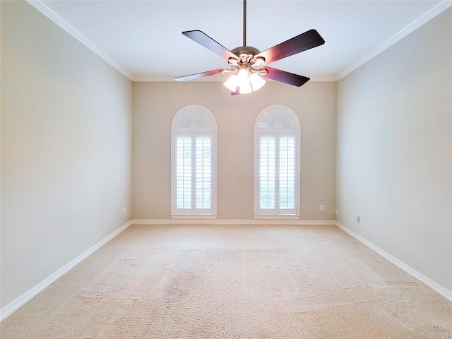 spare room with light colored carpet, a ceiling fan, and ornamental molding
