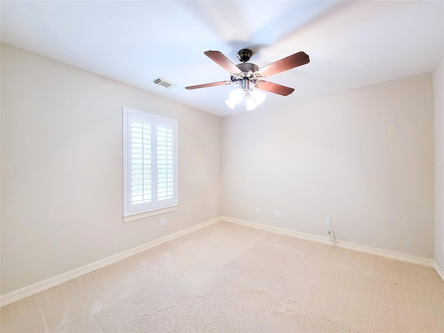 spare room with visible vents, baseboards, ceiling fan, and light colored carpet
