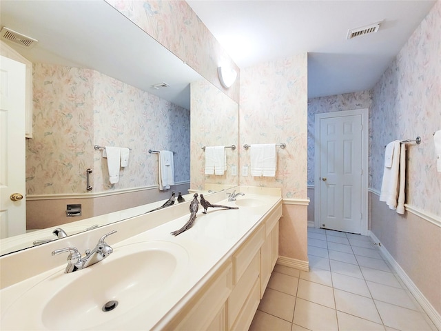 bathroom with tile patterned floors, visible vents, and a sink