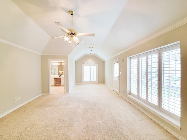 unfurnished living room featuring carpet floors, baseboards, ceiling fan, and vaulted ceiling