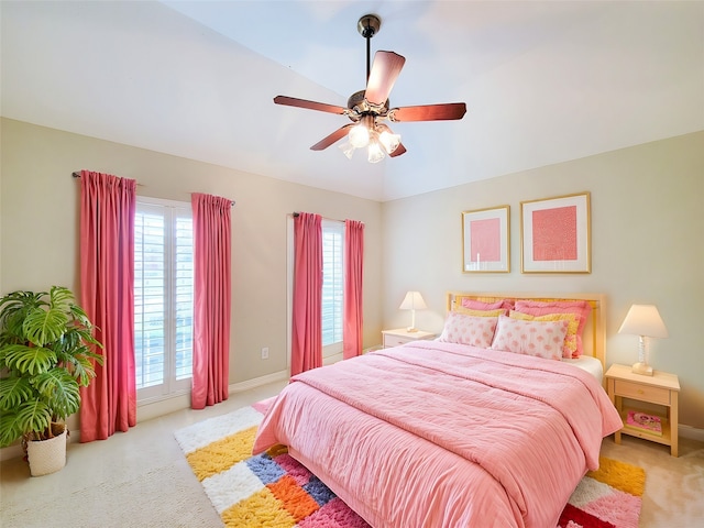 carpeted bedroom with a ceiling fan and baseboards