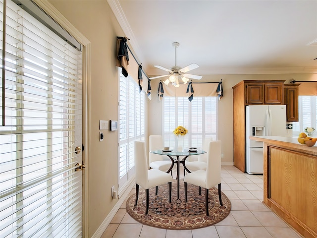dining room with plenty of natural light, ornamental molding, and a ceiling fan