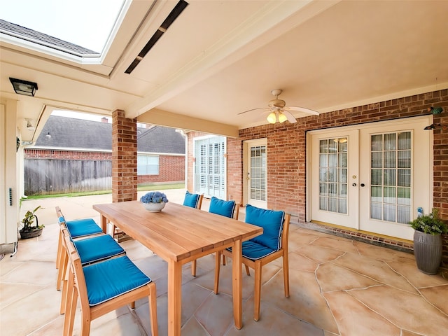 view of patio with ceiling fan, fence, french doors, and outdoor dining area