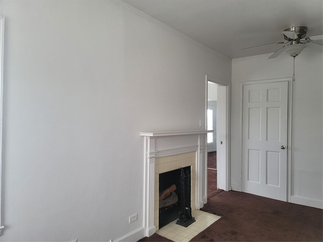 unfurnished living room featuring a tile fireplace, light carpet, a ceiling fan, baseboards, and ornamental molding