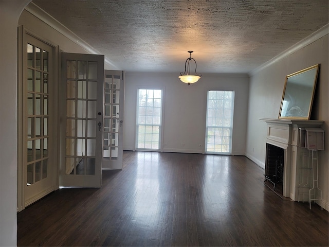 unfurnished living room featuring a textured ceiling, ornamental molding, dark wood-type flooring, and a fireplace