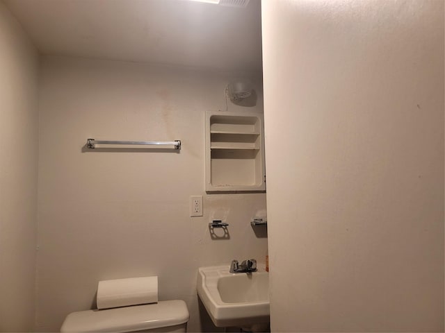 bathroom featuring a sink and toilet