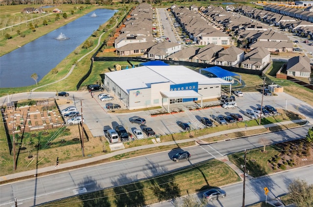 drone / aerial view featuring a water view and a residential view