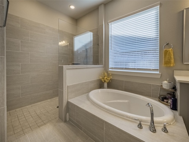 bathroom featuring a garden tub and walk in shower