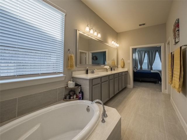 bathroom featuring ensuite bathroom, visible vents, a sink, and a bath