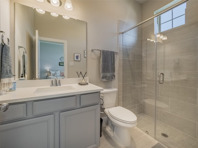 bathroom featuring a stall shower, toilet, vanity, and ensuite bath