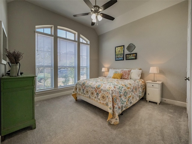 bedroom featuring light carpet, ceiling fan, lofted ceiling, and baseboards