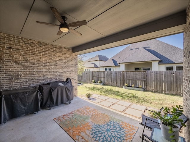 view of patio with ceiling fan, a fenced backyard, and area for grilling