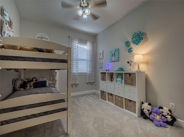 carpeted bedroom with ceiling fan and baseboards