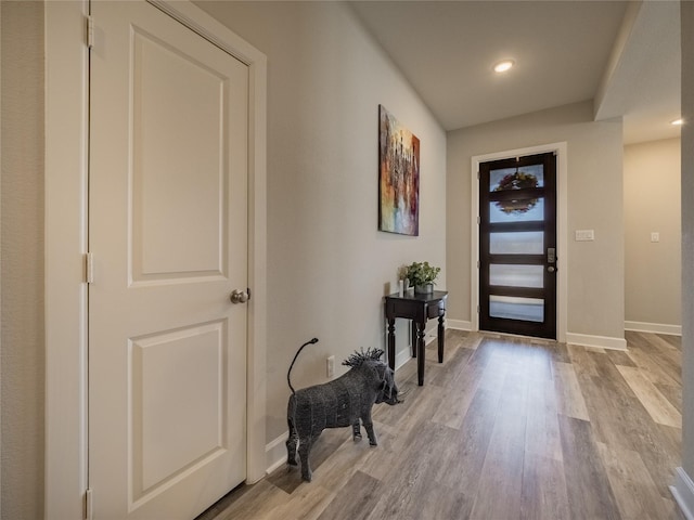 entryway with baseboards, recessed lighting, and light wood-style floors