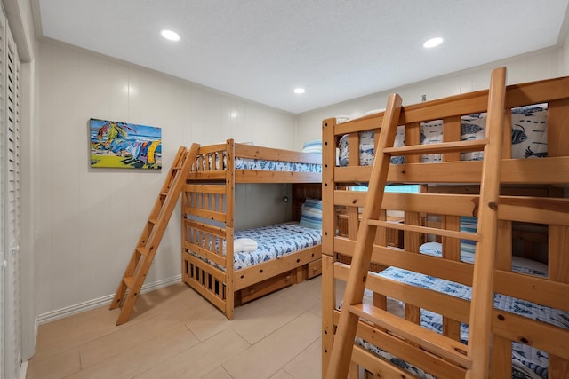 bedroom featuring light tile patterned flooring and recessed lighting