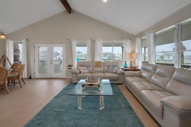 living room with plenty of natural light, high vaulted ceiling, beam ceiling, and french doors