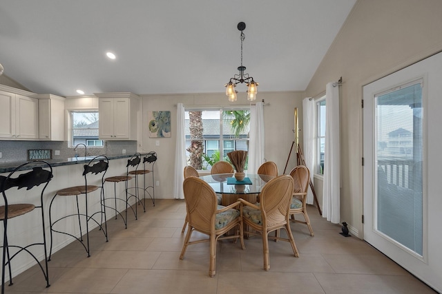 dining area featuring light tile patterned floors, vaulted ceiling, and recessed lighting