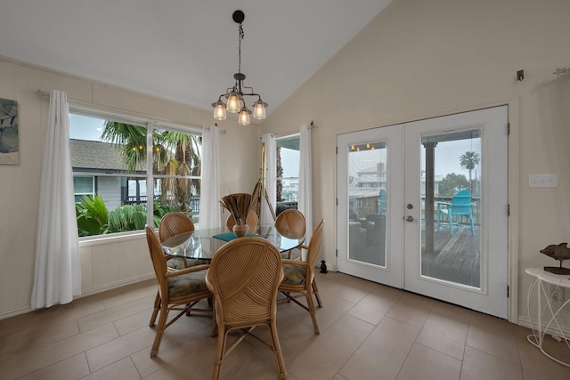 dining area featuring lofted ceiling, french doors, and light tile patterned floors