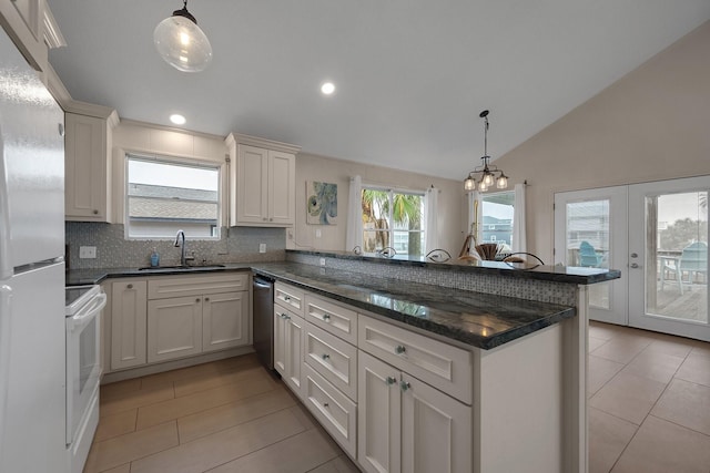 kitchen with white electric stove, a peninsula, a sink, white cabinetry, and hanging light fixtures