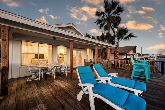 deck at dusk with outdoor dining area