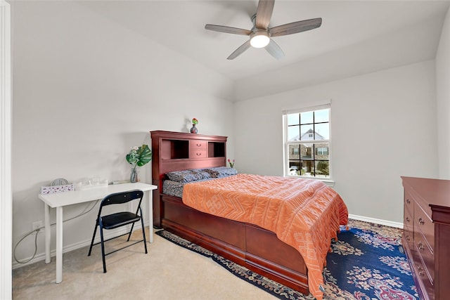 bedroom featuring light carpet, a ceiling fan, and baseboards