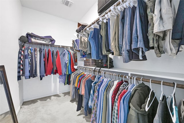 spacious closet with light colored carpet and visible vents