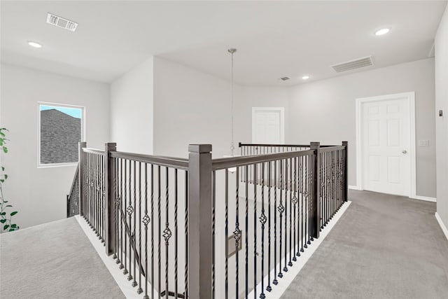 hallway with carpet, visible vents, and recessed lighting