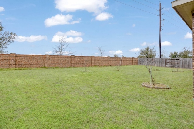 view of yard with a fenced backyard