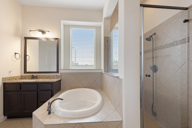 full bath featuring a garden tub, tile patterned flooring, a shower stall, and vanity