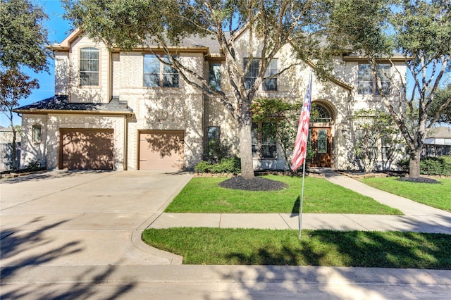 multi unit property with driveway, an attached garage, a front lawn, and brick siding