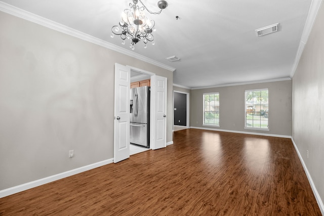 unfurnished living room featuring baseboards, visible vents, and wood finished floors